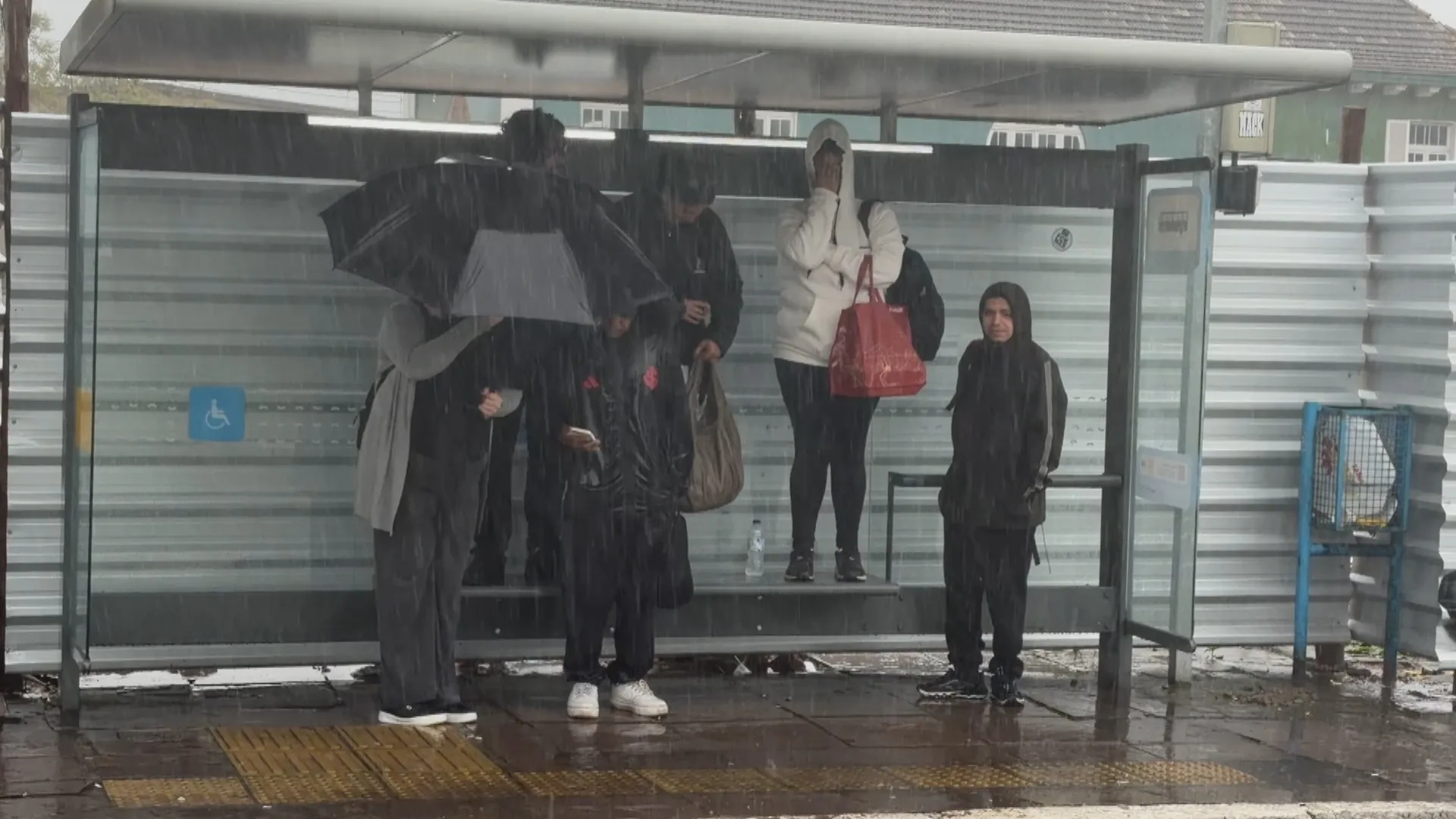 Passageiros buscam refúgio em bancos de parada durante temporal em Porto Alegre